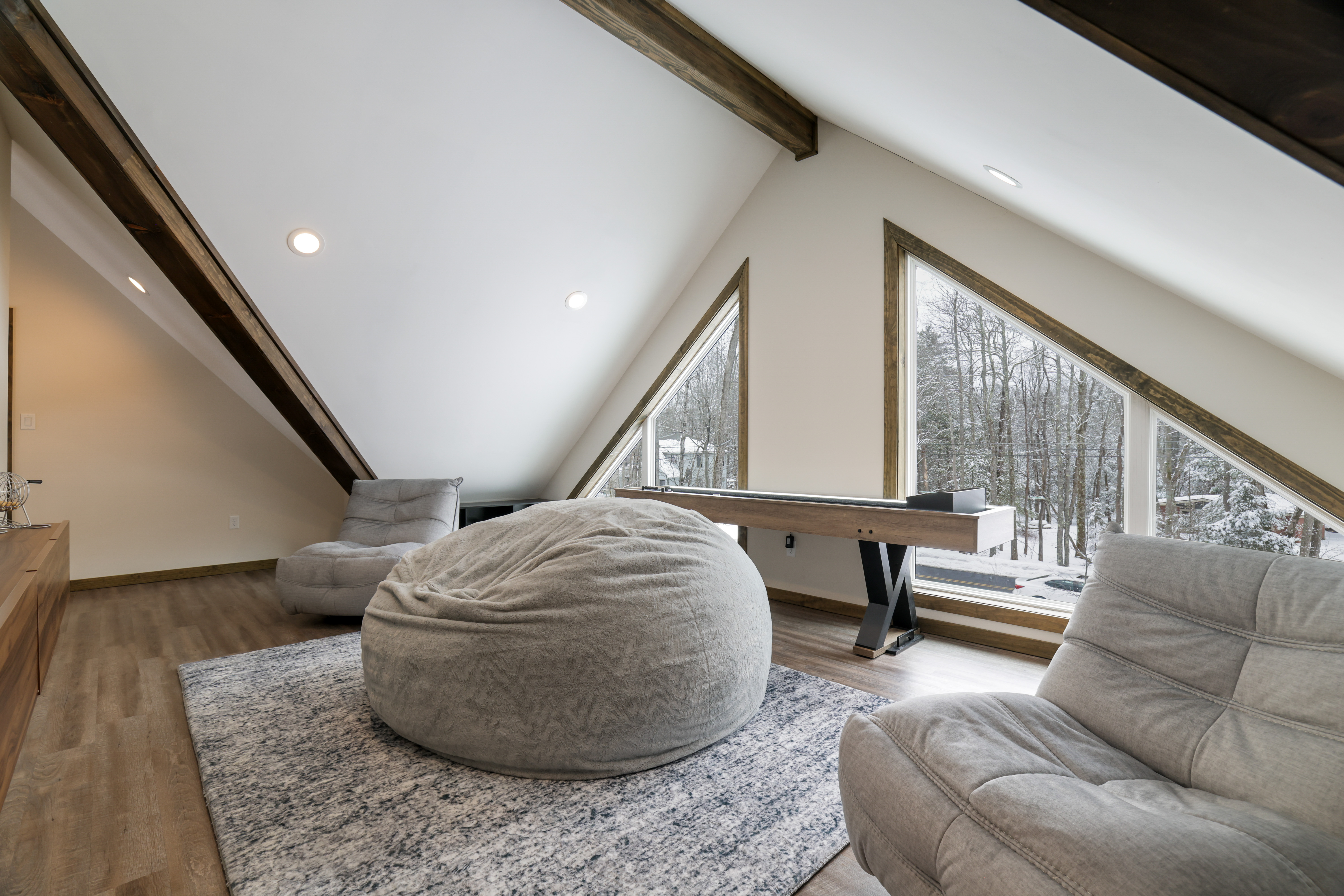 Loft game room with shuffleboard and bean bags